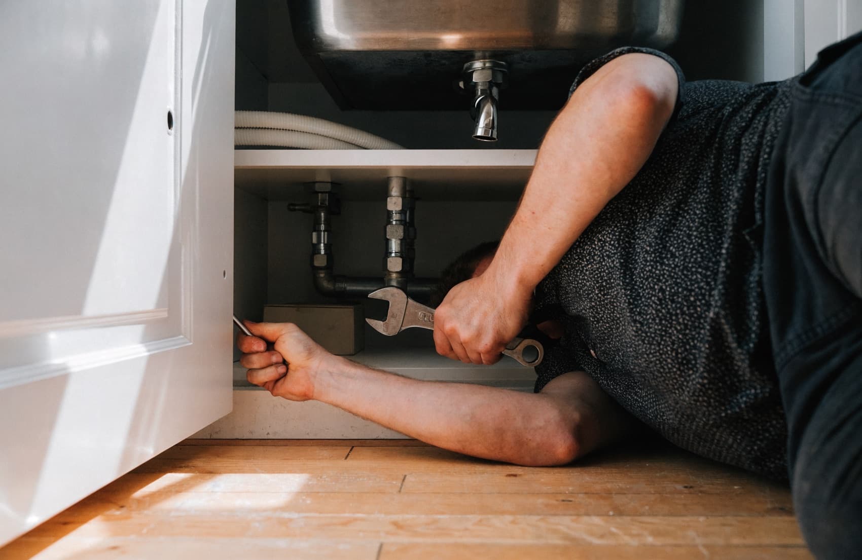 A plumber on a job, the kind of authentic photo that strengthens a Google Business Profile